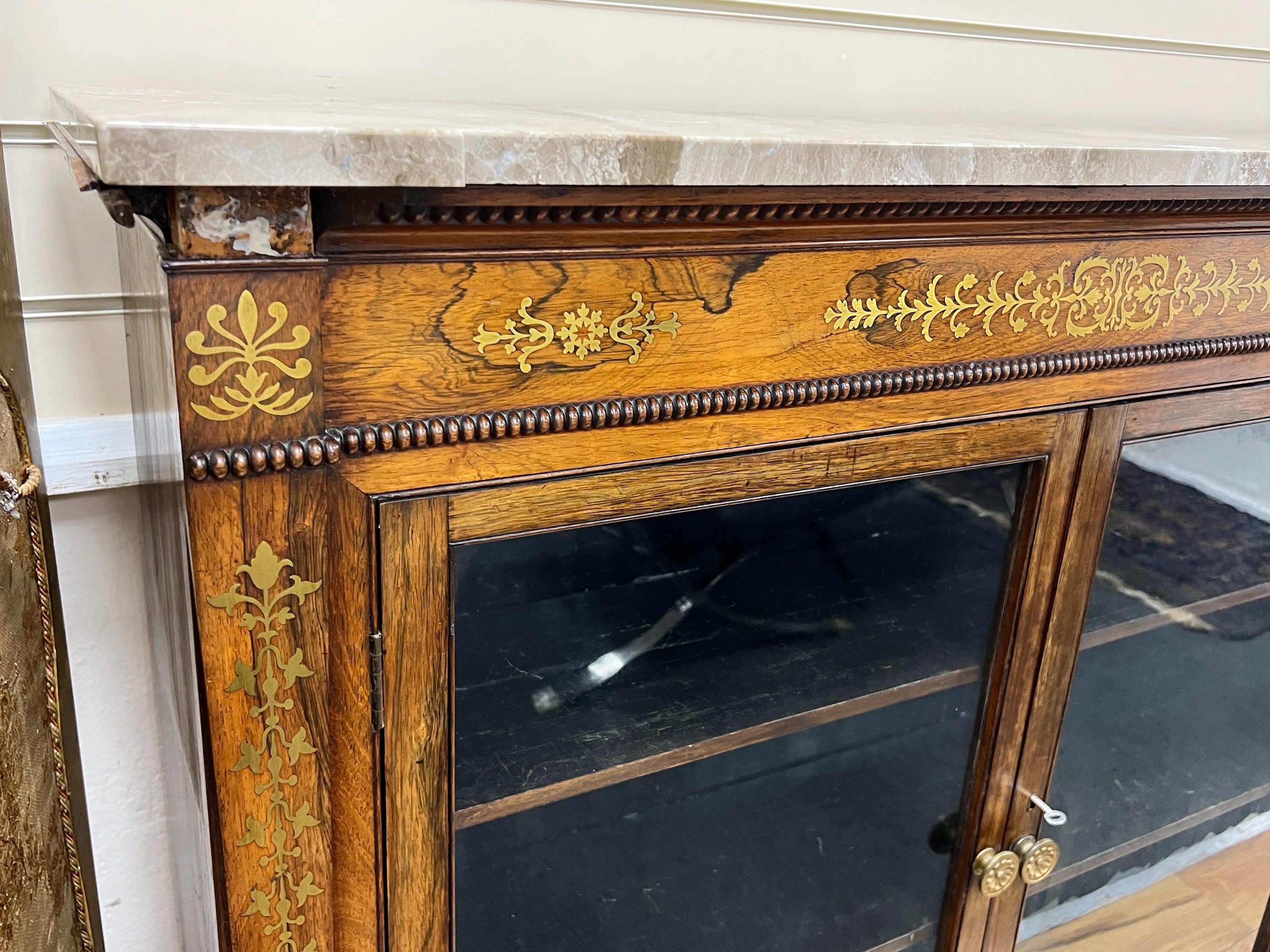 A Regency brass inlaid rosewood marble topped side cabinet, width 121cm, depth 30cm, height 107cm